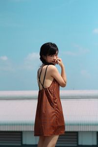 Full length of woman standing by sea against sky