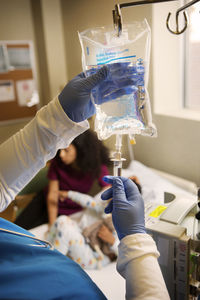 Nurse setting iv drip in hospital