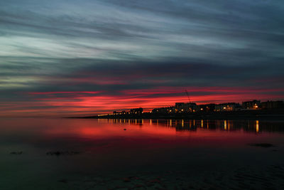 Scenic view of sea against romantic sky at sunset