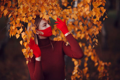 Full length of girl standing on leaves during autumn