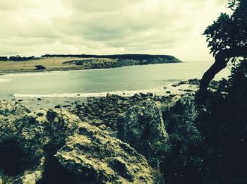 Scenic view of sea against cloudy sky