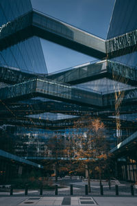 Low angle view of bridge and buildings against sky during winter