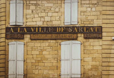 Close-up of text on brick wall
