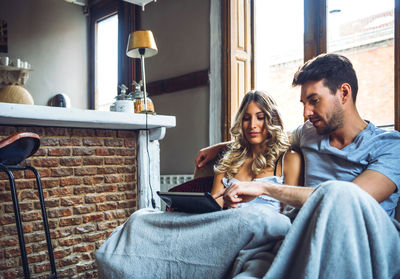 Young couple sitting at home