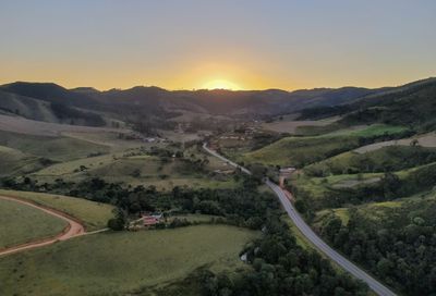 Scenic view of landscape against clear sky during sunset