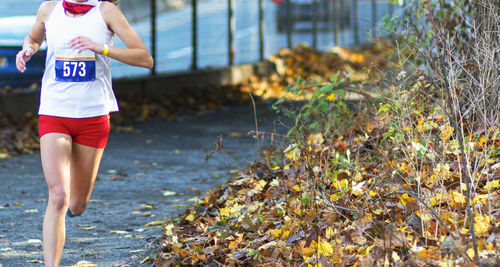 Midsection of woman running outdoors