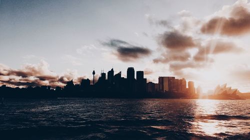 City at waterfront during sunset