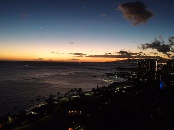 View of city at waterfront during sunset