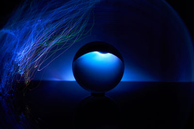 Close-up of illuminated ball against black background