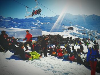 People skiing on snow covered field