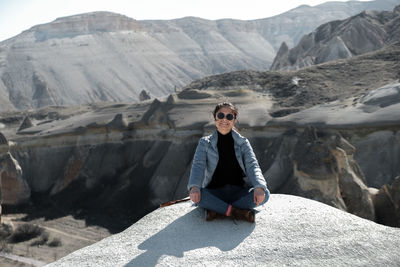 Portrait of woman standing on mountain