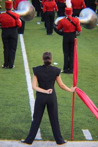 Rear view of men standing on field