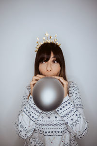 Portrait of cute girl with christmas decoration against white background