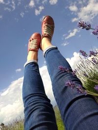 Low section of woman against sky