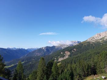 Scenic view of mountains against blue sky