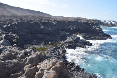 Scenic view of sea and rocks against sky