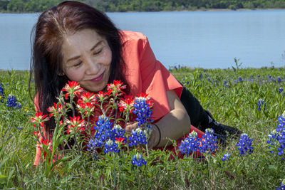 Woman with pink flowers on field