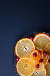 Directly above shot of oranges against black background