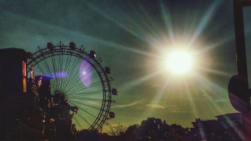 Low angle view of ferris wheel against sky