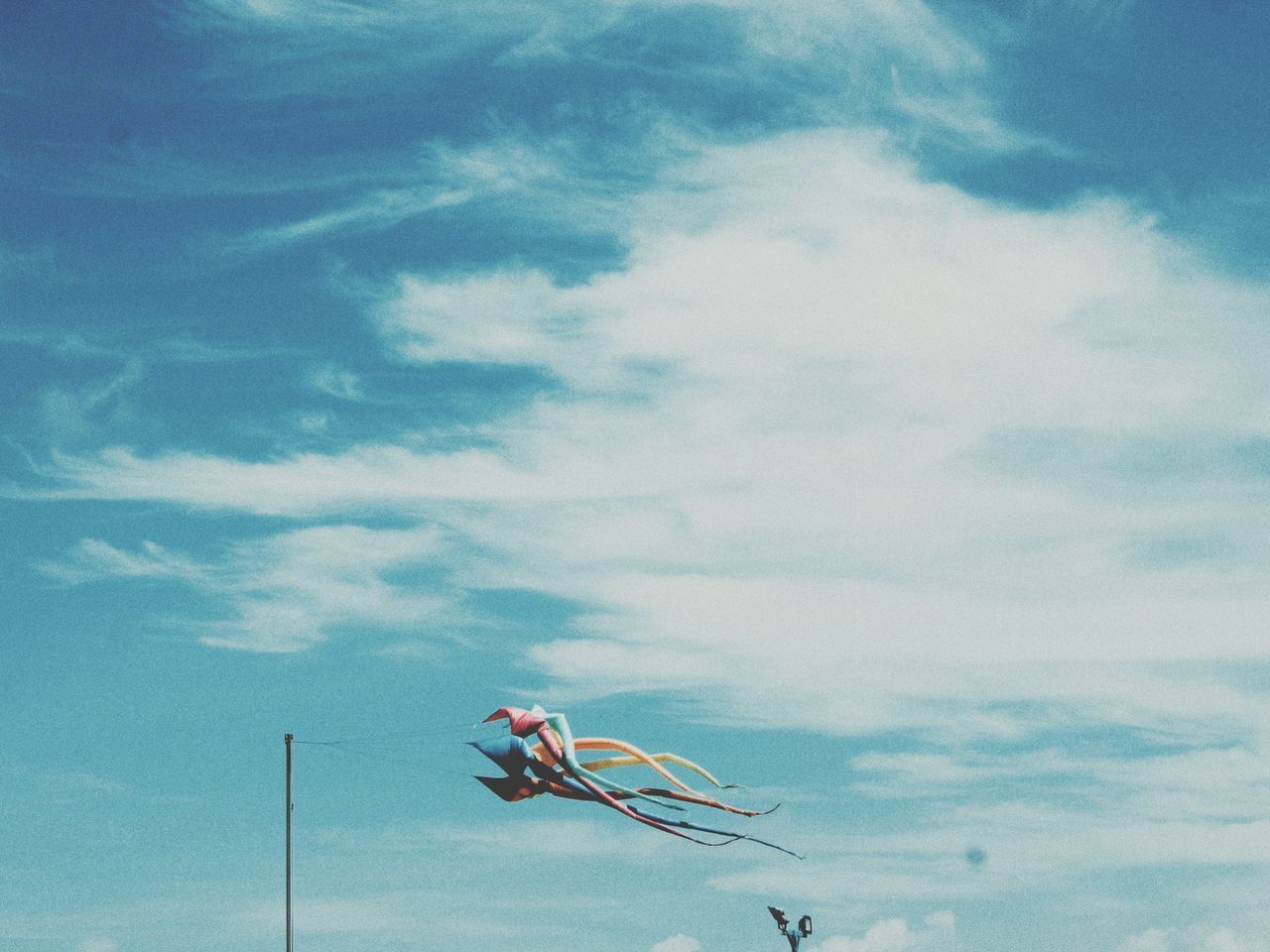 LOW ANGLE VIEW OF KITE FLYING HANGING AGAINST SKY