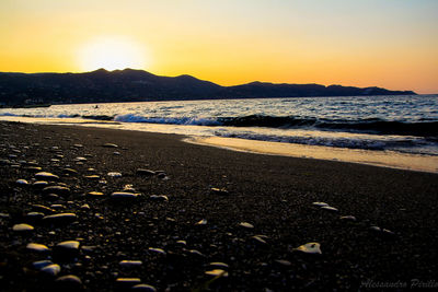 Scenic view of beach against sky during sunset