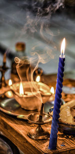 Close-up of lit candles on table