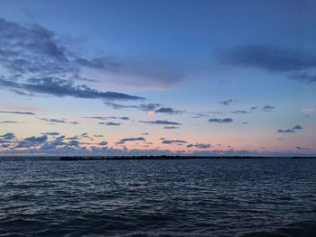 Scenic view of sea against sky at sunset