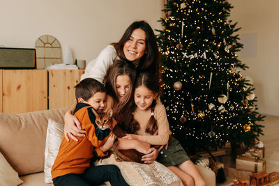 A large family celebrates christmas holidays at home. mom with teenage children in living room