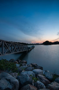 Floating jetty over lake against sky during sunset