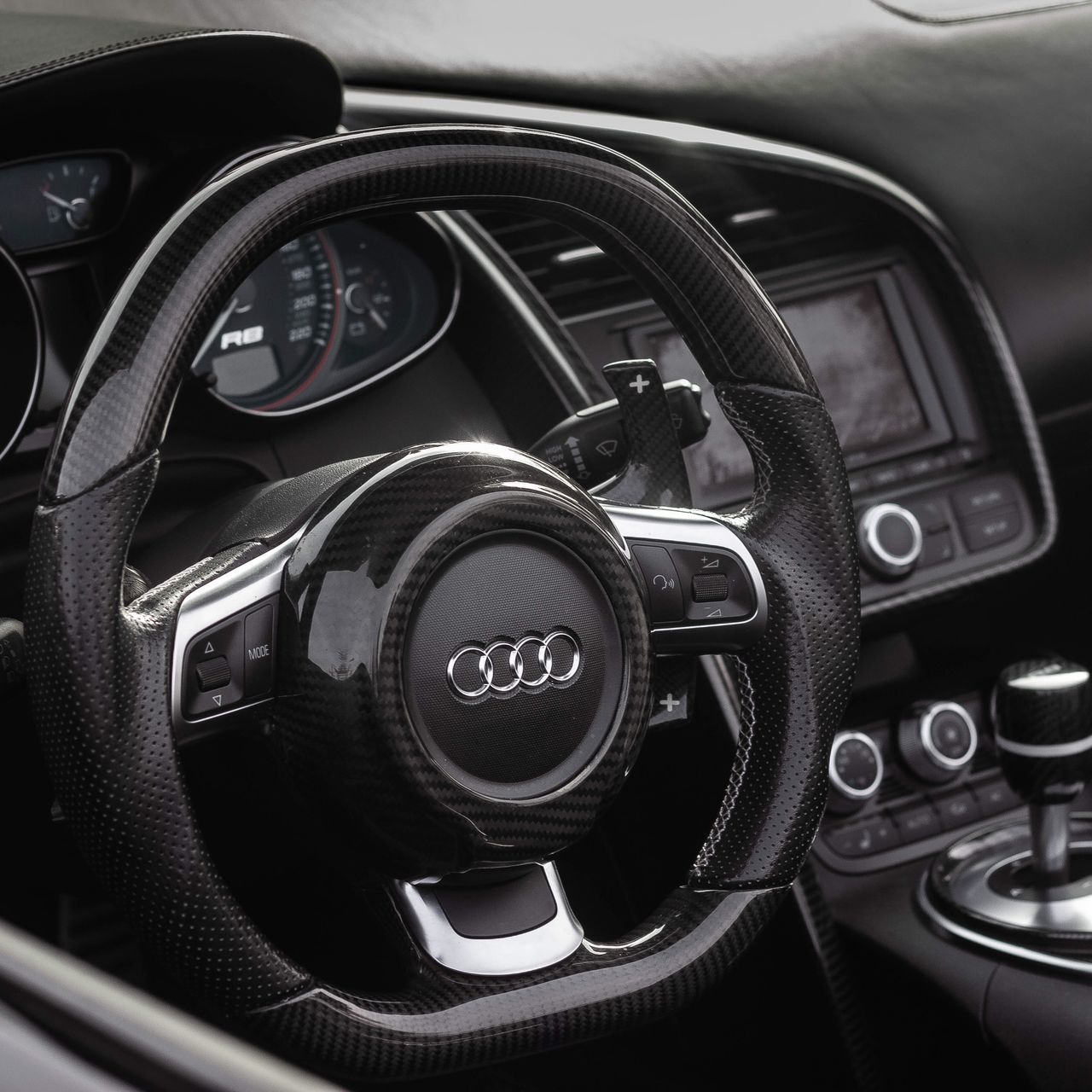 mode of transportation, transportation, car interior, motor vehicle, car, vehicle interior, land vehicle, steering wheel, dashboard, control panel, gearshift, speedometer, black color, close-up, indoors, no people, control, vehicle part, travel, wealth, luxury, leather, digital camera