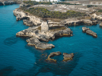 High angle view of rocks on sea shore