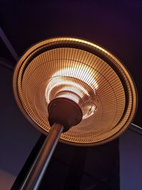 Low angle view of illuminated lamp at night