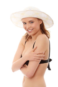 Portrait of smiling young woman against white background