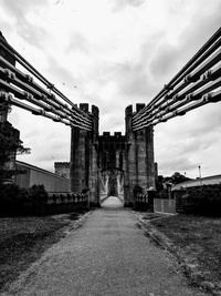 Low angle view of bridge against cloudy sky