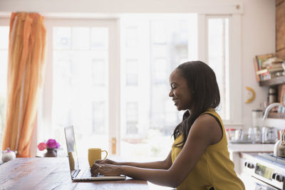 Businesswoman working on her laptop from home