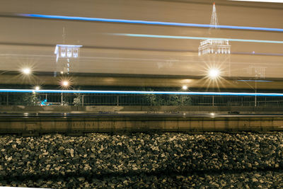 Illuminated railroad tracks at night