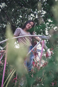 Low angle view of woman on plants