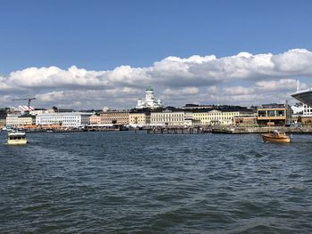 Scenic view of sea and buildings against sky