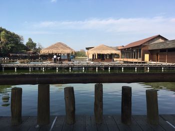 Building by lake against sky