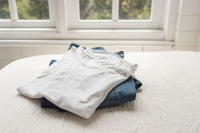 White cat lying on bed at home