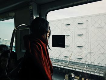 Man looking through window