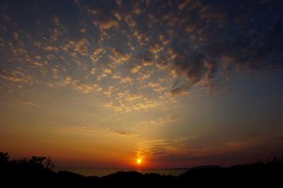 Scenic view of dramatic sky over sea during sunset