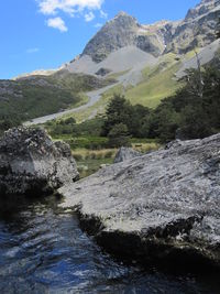 Scenic view of river amidst mountains against sky