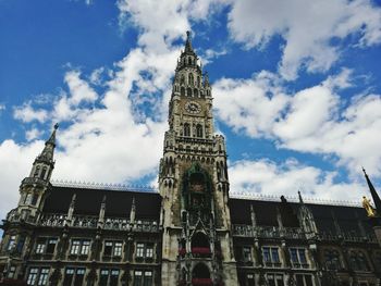 Low angle view of rathaus-glockenspiel against sky in city