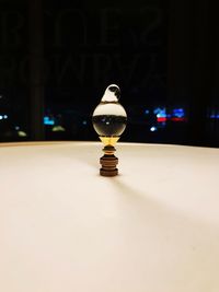 Close-up of illuminated light bulb on table