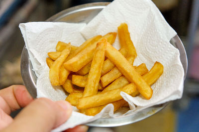 Cropped image of person holding burger