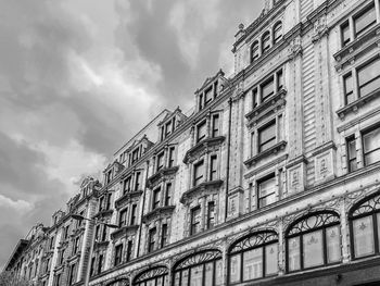 Low angle view of building against cloudy sky