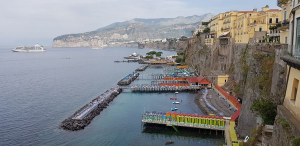 High angle view of buildings by sea against sky