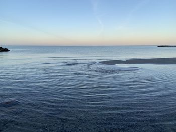 Scenic view of sea against clear sky during sunset