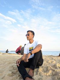 A man sitting on the beach. beach view of an empty island which is a tourist spot